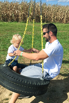 Matt Hostettler and his son swinging